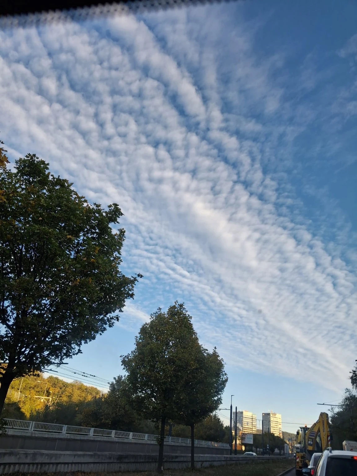 A patterned morning sky over a city